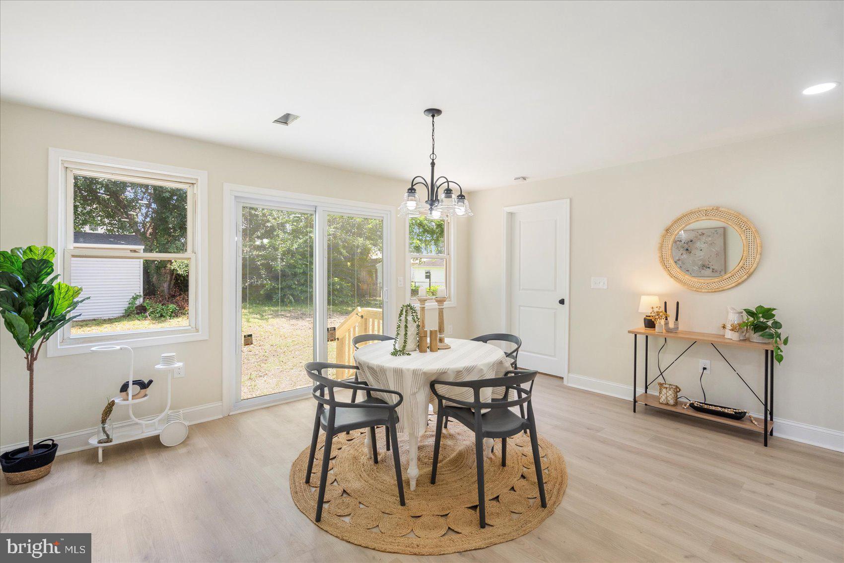 8111 Holly Road Curtis Bay, MD 21226 - Photo 20 of 46 a view of a dining room with furniture window and wooden floor