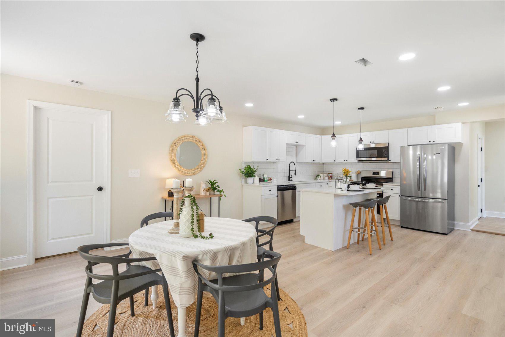 8111 Holly Road Curtis Bay, MD 21226 - Photo 21 of 46 a view of a dining room with furniture and wooden floor
