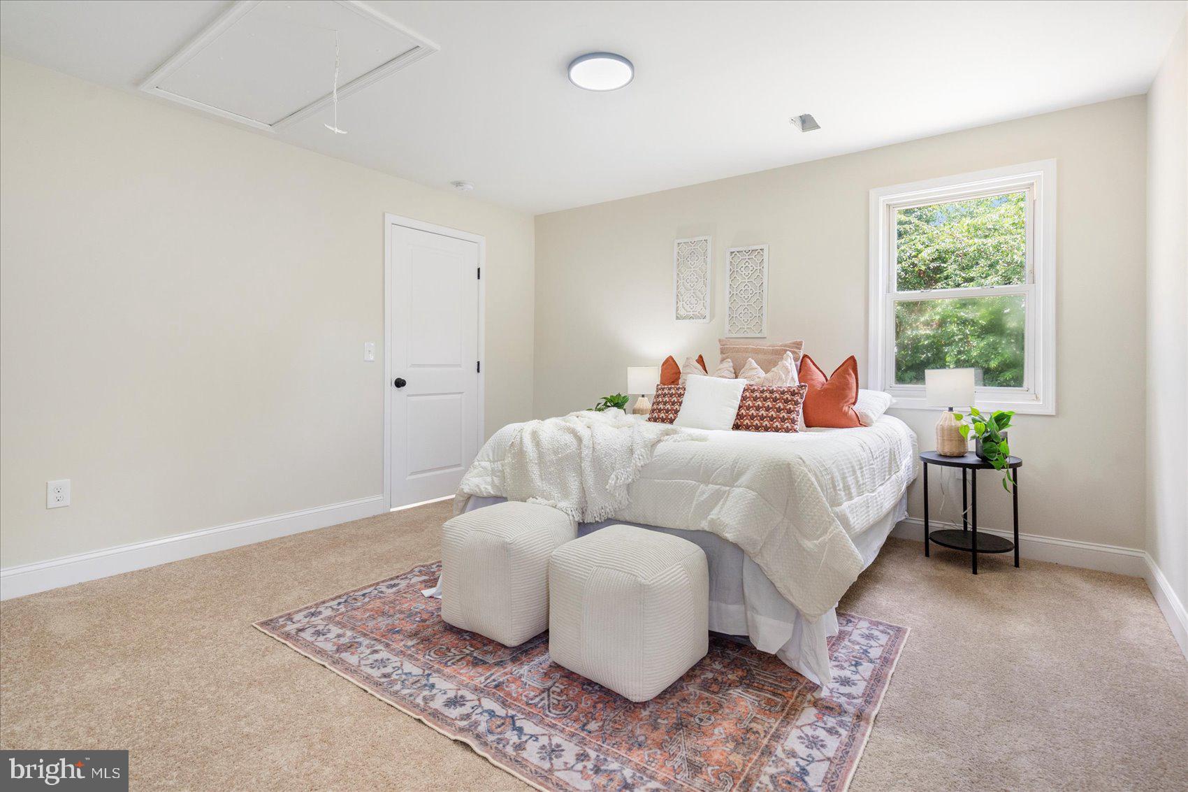 8111 Holly Road Curtis Bay, MD 21226 - Photo 25 of 46 a bedroom with a bed and wooden floor