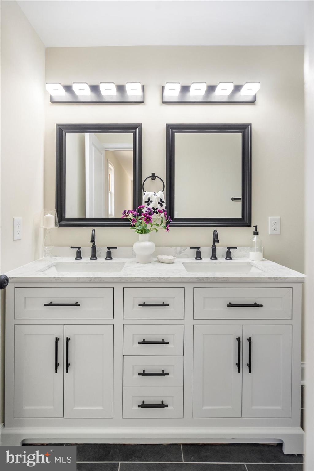 8111 Holly Road Curtis Bay, MD 21226 - Photo 27 of 46 a bathroom with double vanity sinks and a mirror