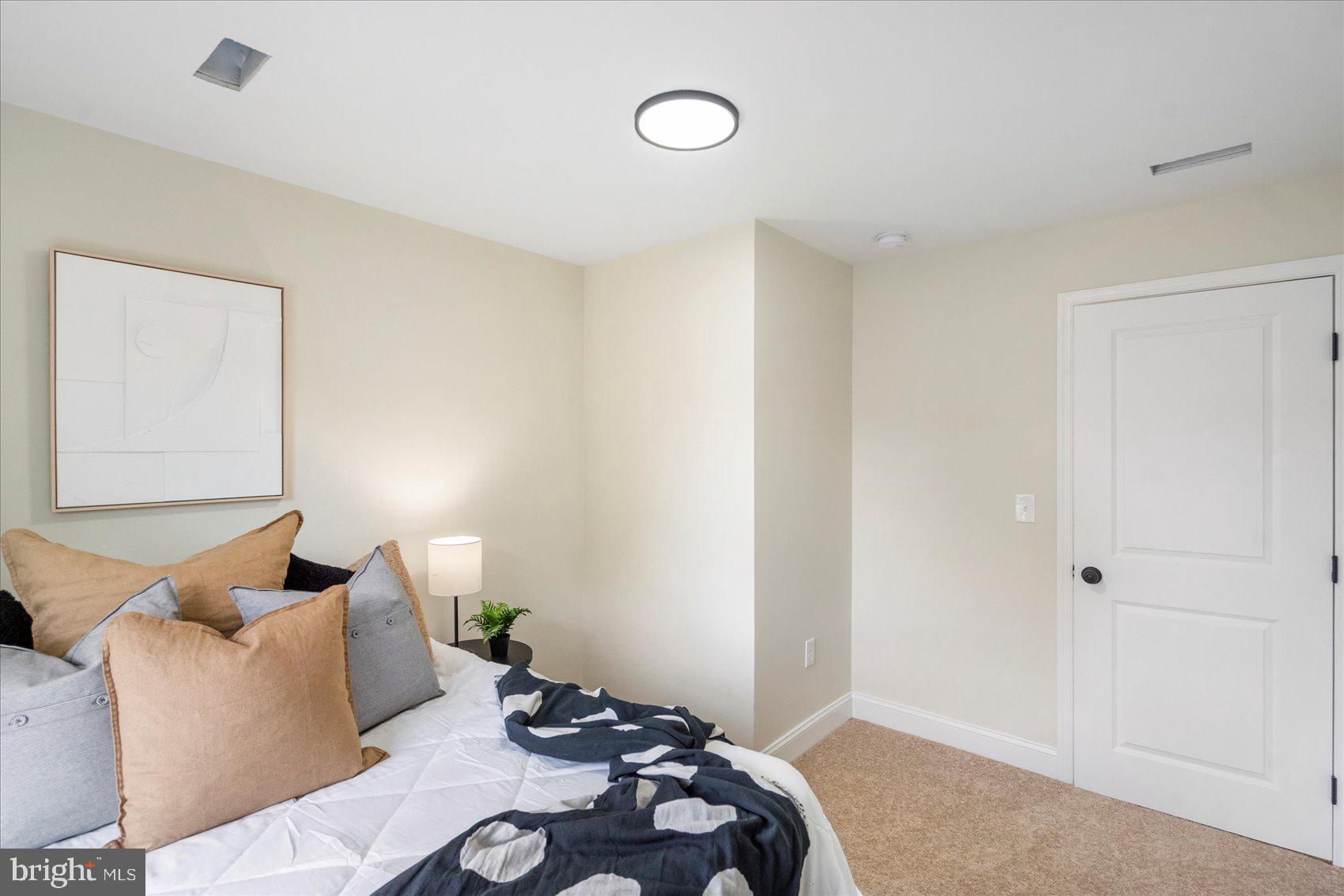 8111 Holly Road Curtis Bay, MD 21226 - Photo 31 of 46 a bedroom with a bed and wooden floor