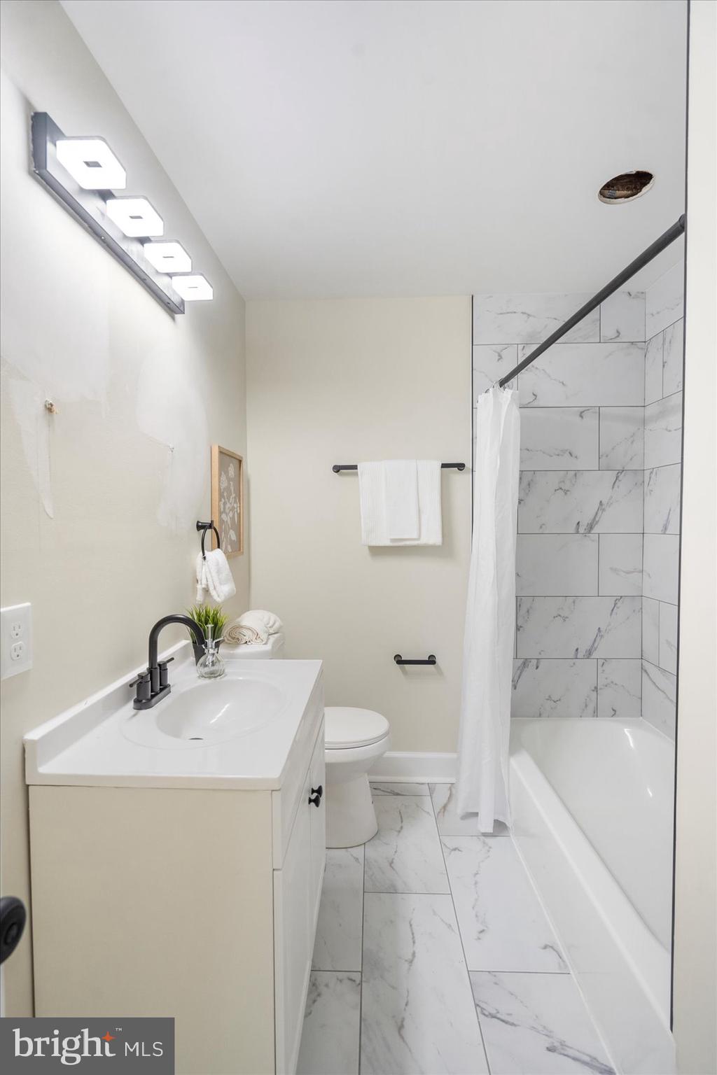 8111 Holly Road Curtis Bay, MD 21226 - Photo 33 of 46 a bathroom with a sink a toilet and shower