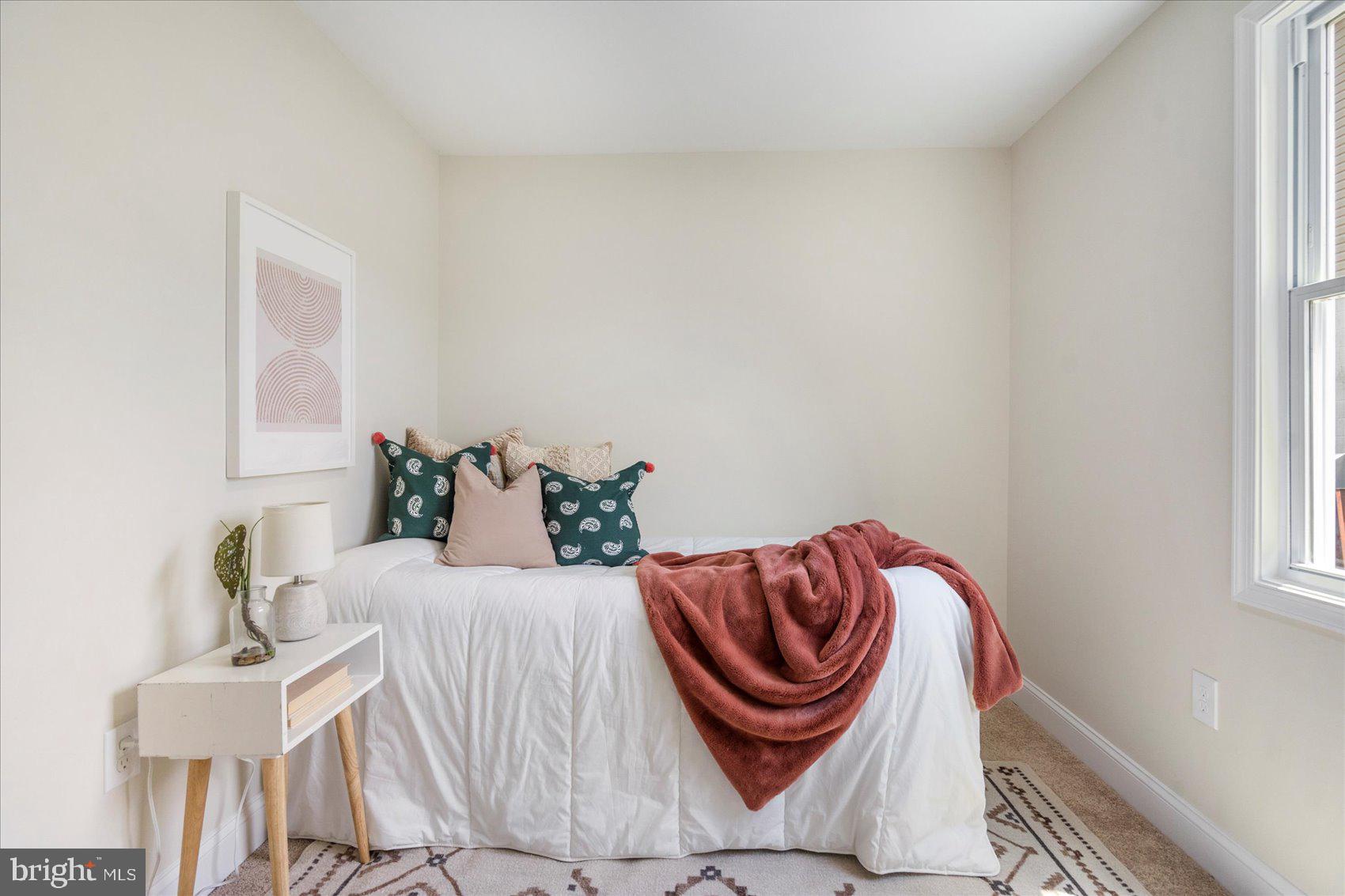 8111 Holly Road Curtis Bay, MD 21226 - Photo 36 of 46 a bedroom with a bed and a chair