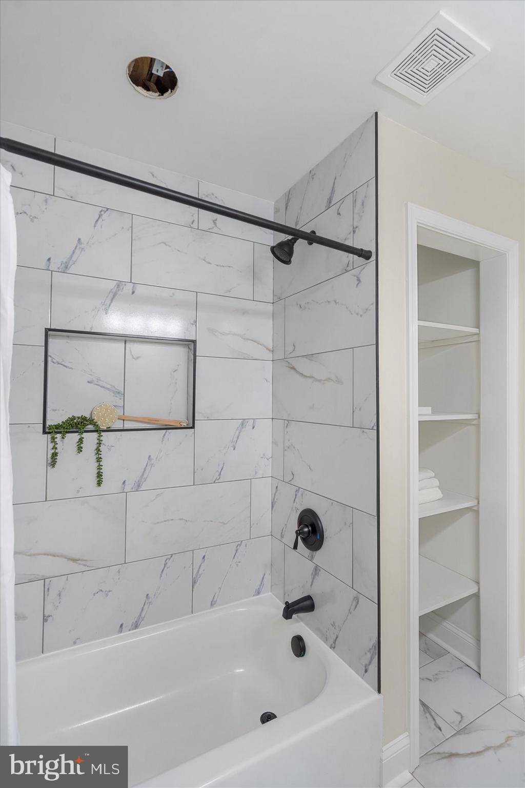 8111 Holly Road Curtis Bay, MD 21226 - Photo 38 of 46 a bathroom with a bathtub and shower