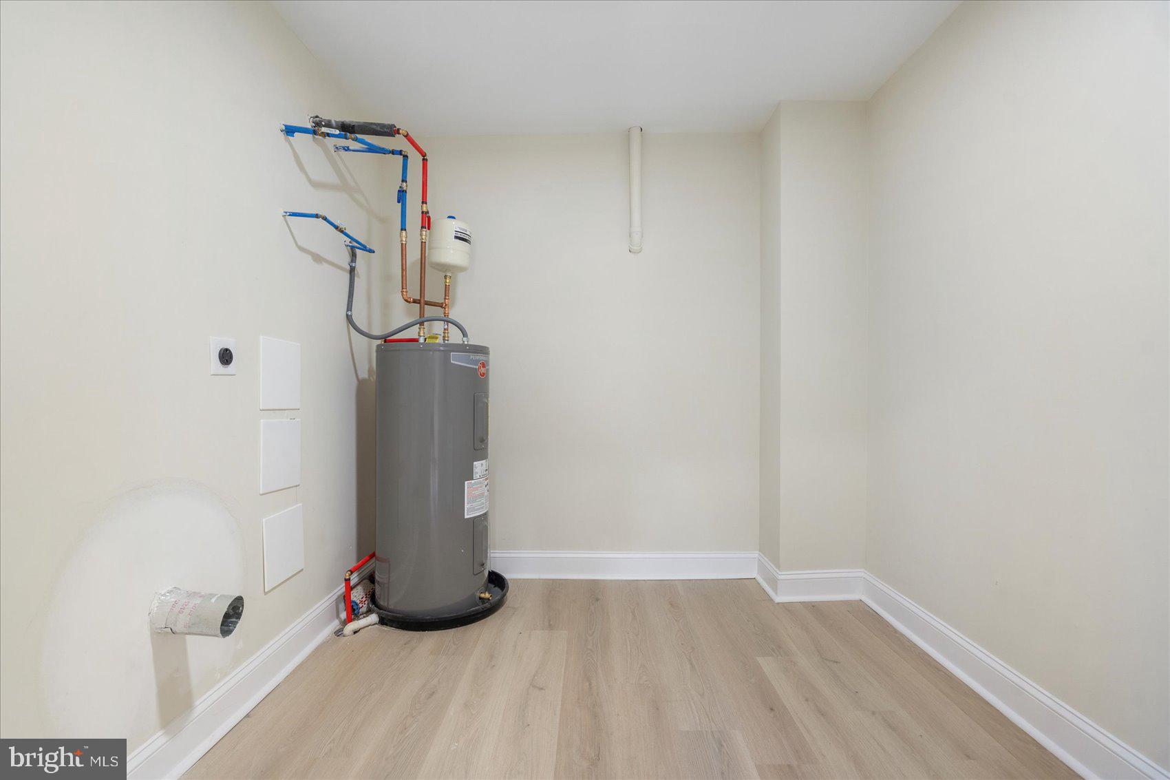 8111 Holly Road Curtis Bay, MD 21226 - Photo 39 of 46 a view of a room with wooden floor and white walls
