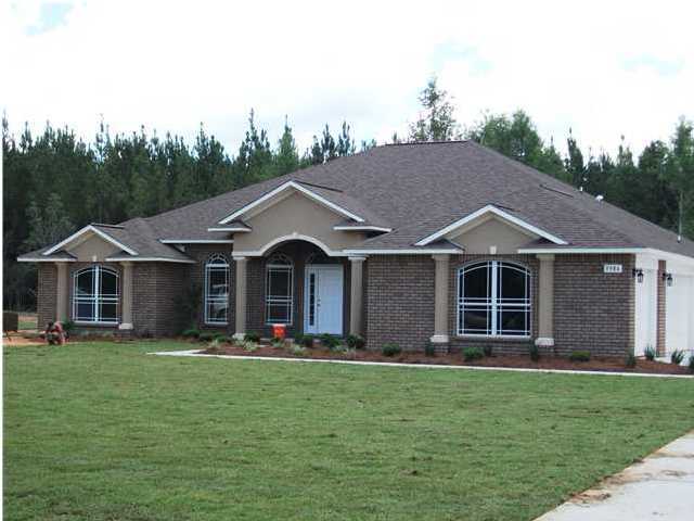 9984 Nichols Lake Road Milton, FL 32583 - Photo 1 of 21 a view of a house with yard and trampoline