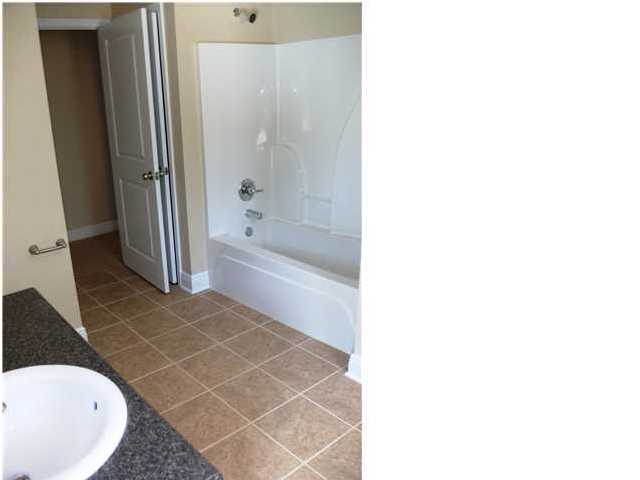 9984 Nichols Lake Road Milton, FL 32583 - Photo 8 of 21 a bathroom with a bathtub and a shower