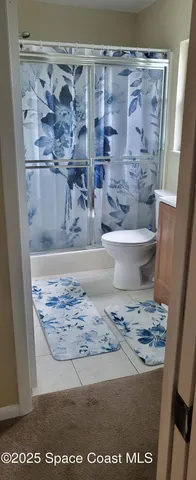 a view of a bedroom with furniture and a window