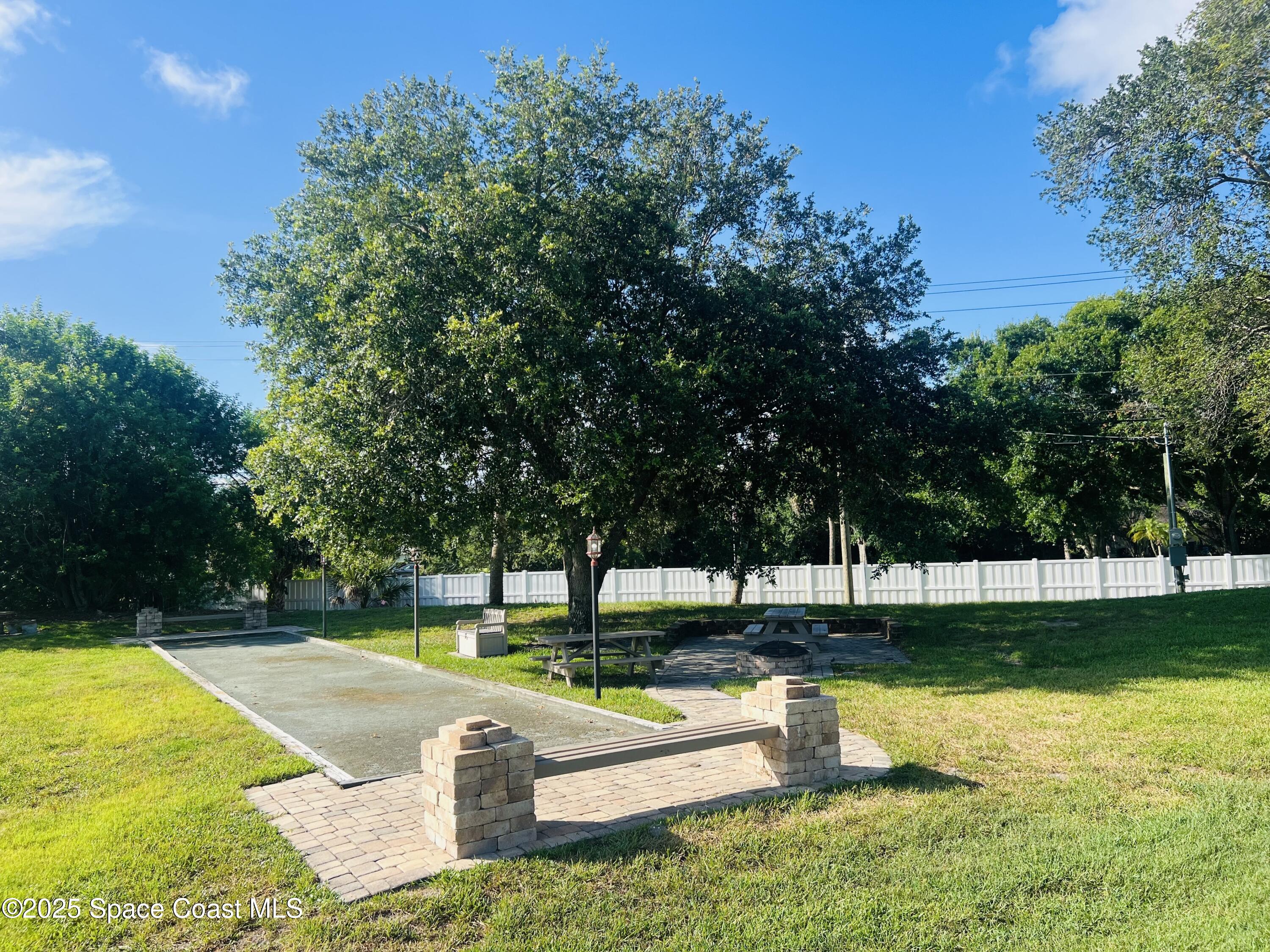 1123 Breezy Way, Unit 8C Sebastian, FL 32958 - Photo 20 of 26 a view of a swimming pool with a yard