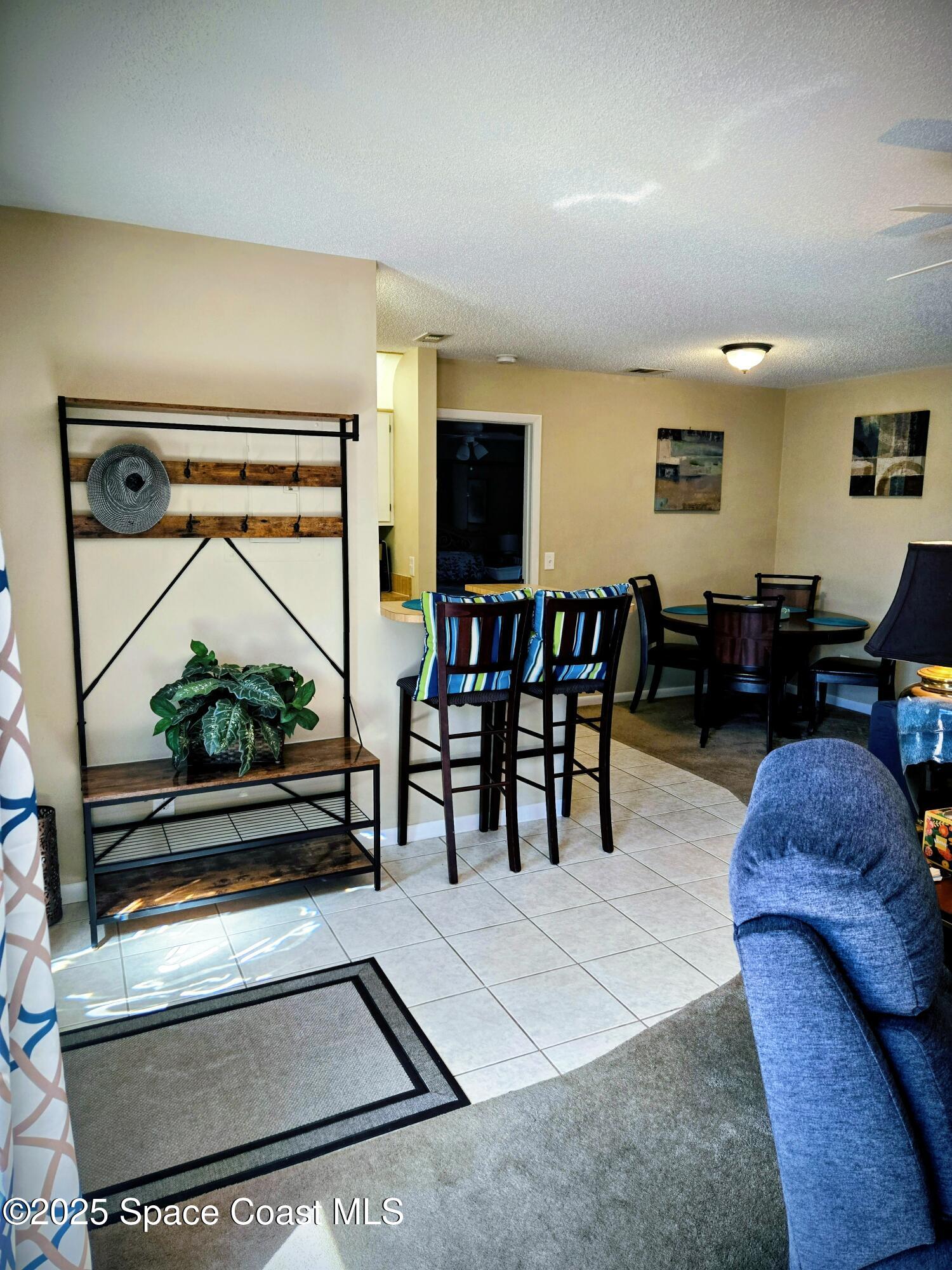 1123 Breezy Way, Unit 8C Sebastian, FL 32958 - Photo 3 of 26 a living room with furniture and a flat screen tv