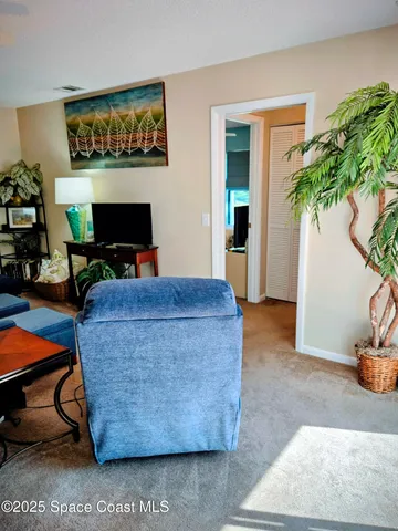 a living room with furniture a potted plant and a fireplace