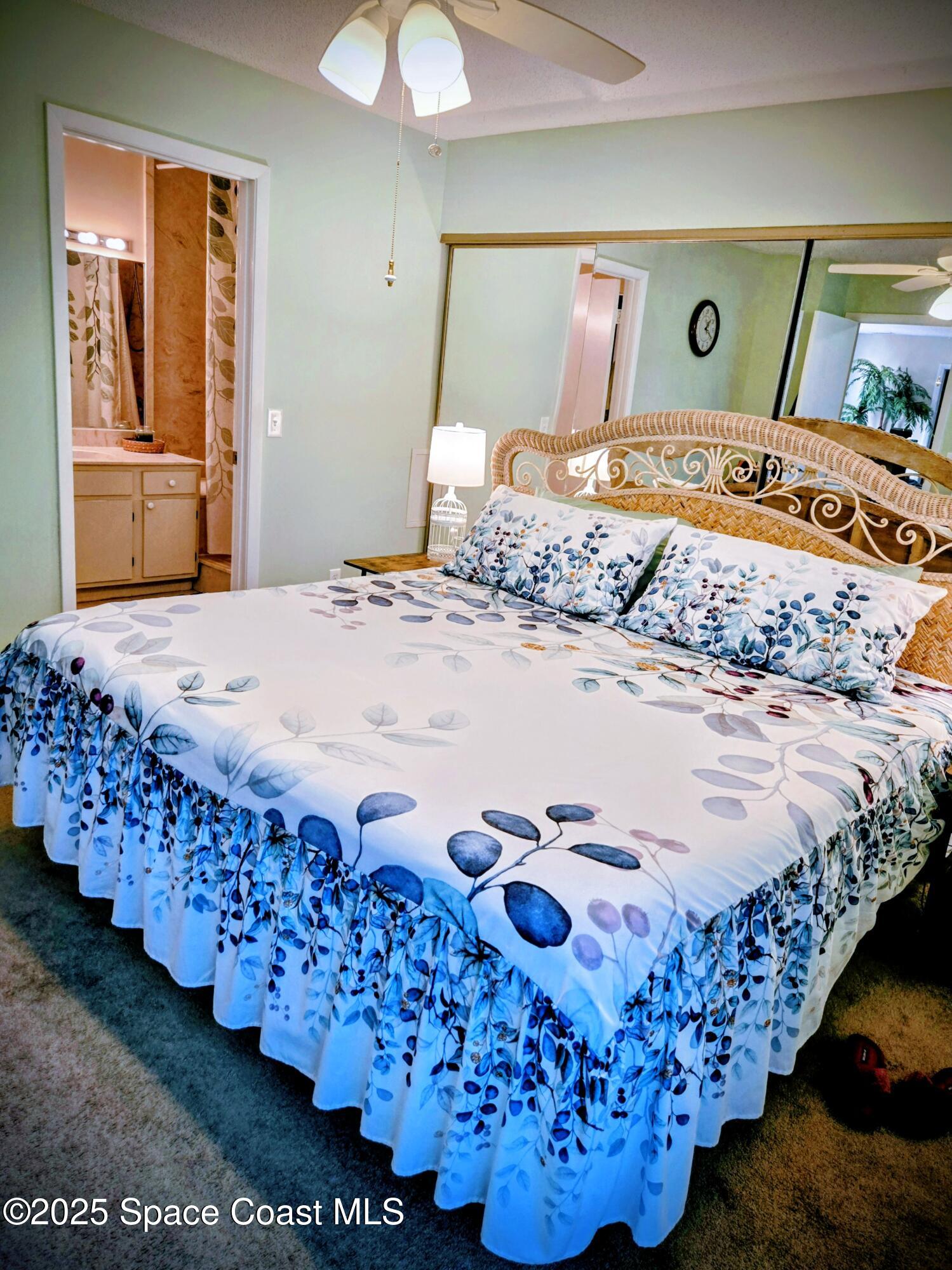 1123 Breezy Way, Unit 8C Sebastian, FL 32958 - Photo 9 of 26 a bed sitting in a bedroom next to a window