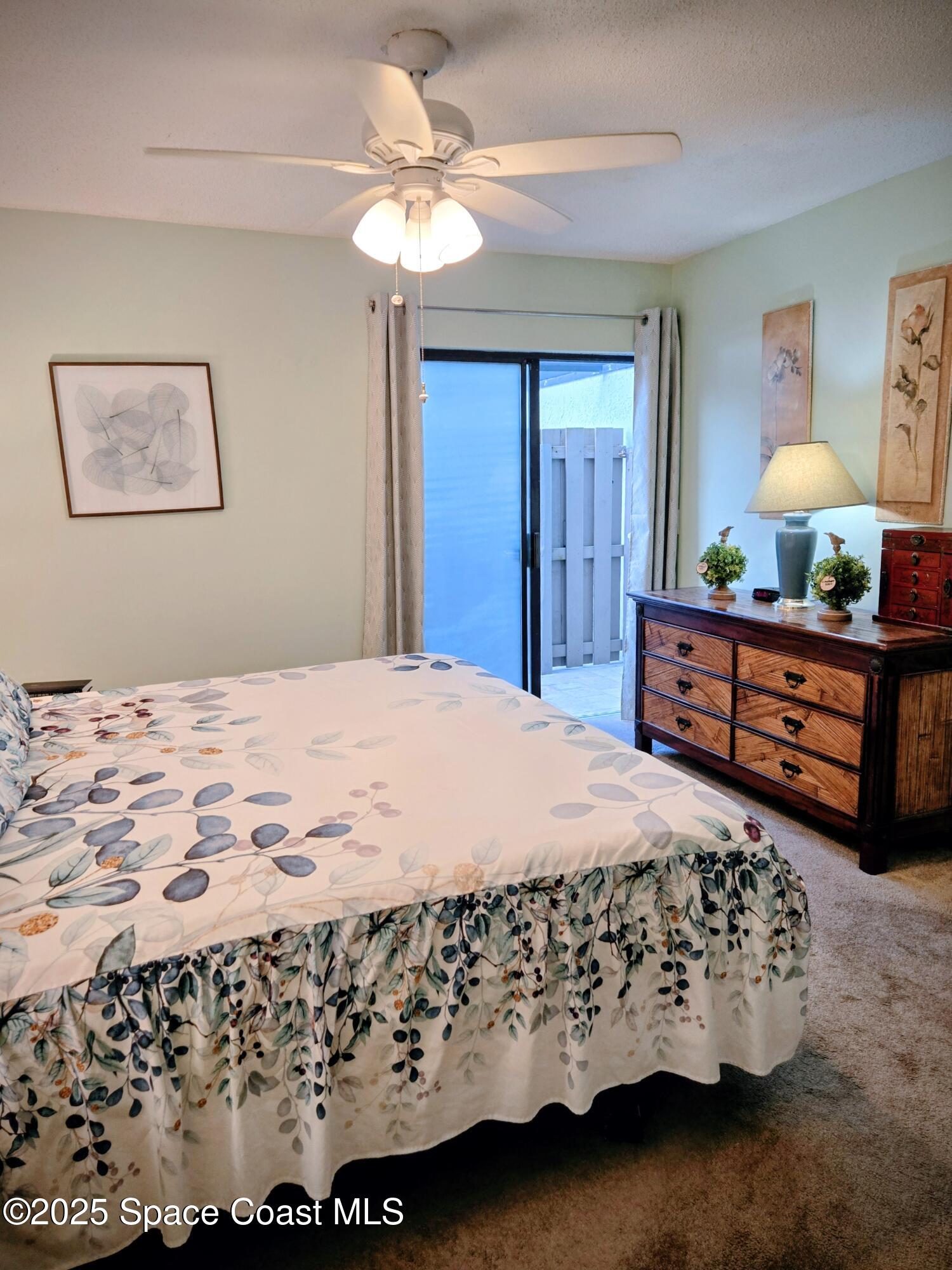 1123 Breezy Way, Unit 8C Sebastian, FL 32958 - Photo 10 of 26 a bedroom with a bed dresser and a window