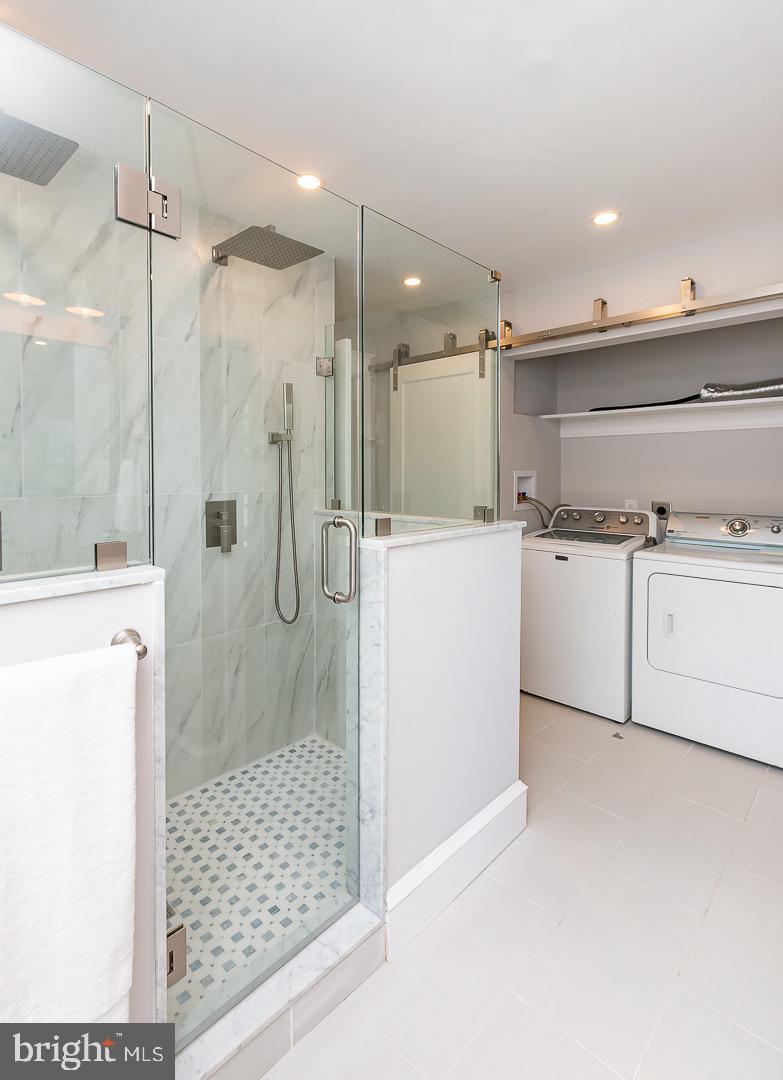 324 Strathmore Road Havertown, PA 19083 - Photo 29 of 53 a bathroom with a shower sink and mirror