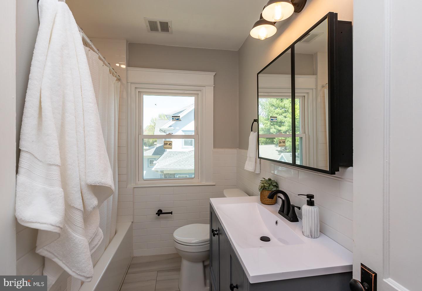 324 Strathmore Road Havertown, PA 19083 - Photo 35 of 53 a bathroom with a sink a toilet and a window