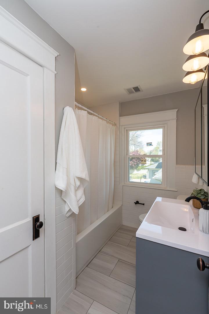 324 Strathmore Road Havertown, PA 19083 - Photo 36 of 53 a bathroom with a sink a mirror and a bathtub