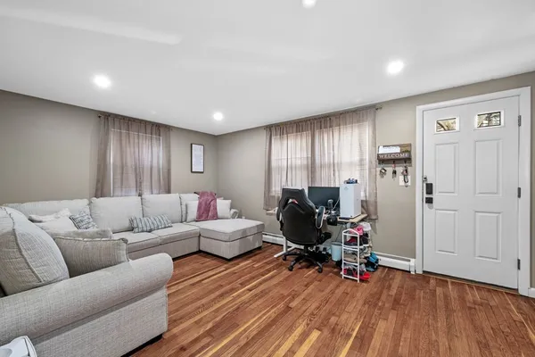 a living room with furniture and wooden floor