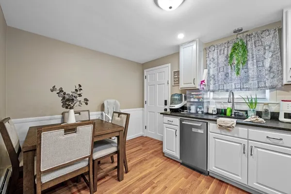 a kitchen with a table chairs stove and cabinets
