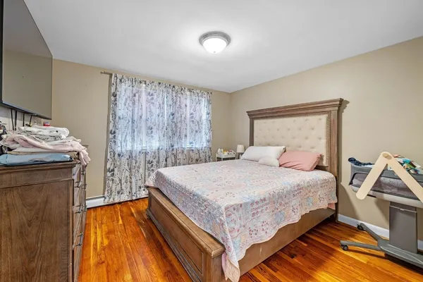 a bedroom with a bed and a dresser