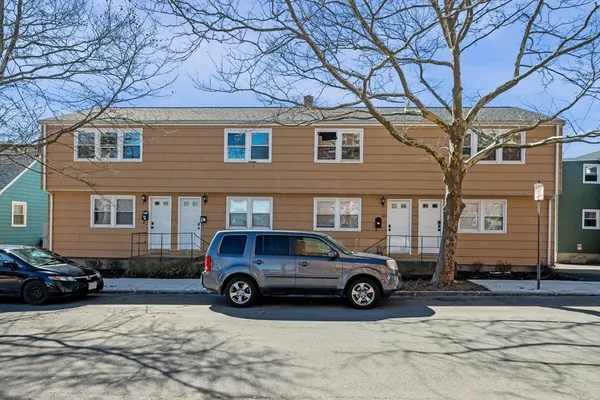a car parked in front of a brick house