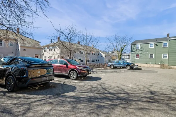 a view of a cars is parked in front of a house