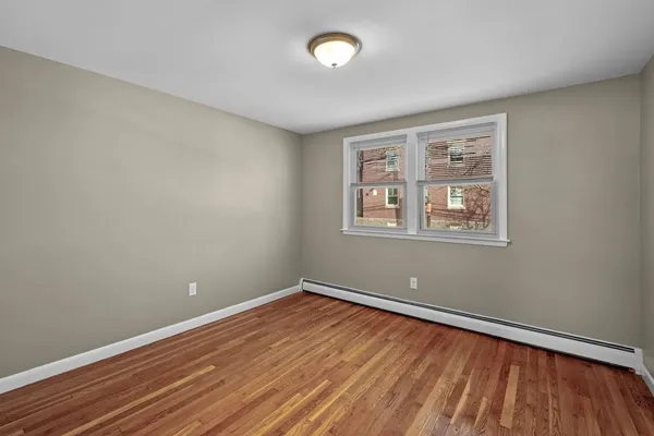 a view of a room with wooden floor and windows