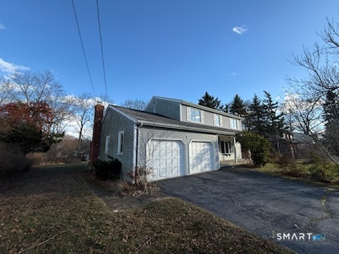 122 Cornfield Road Milford, CT 06461 - Photo 2 of 14 a front view of a house with a yard and garage