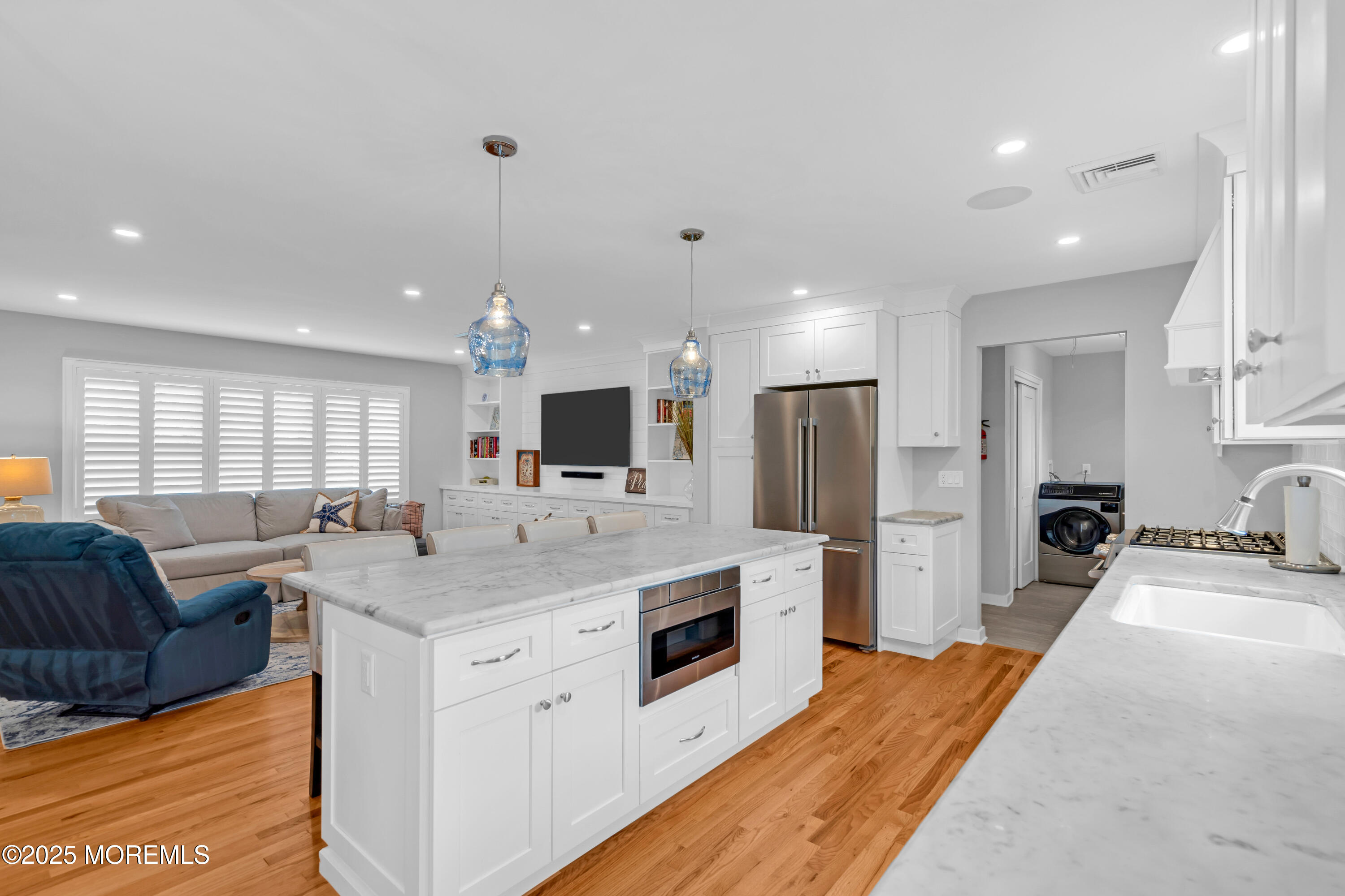 2419 Kipling Avenue Spring Lake Heights, NJ 07762 - Photo 11 of 37 a large kitchen with stainless steel appliances kitchen island a large counter top a sink a stove and a refrigerator