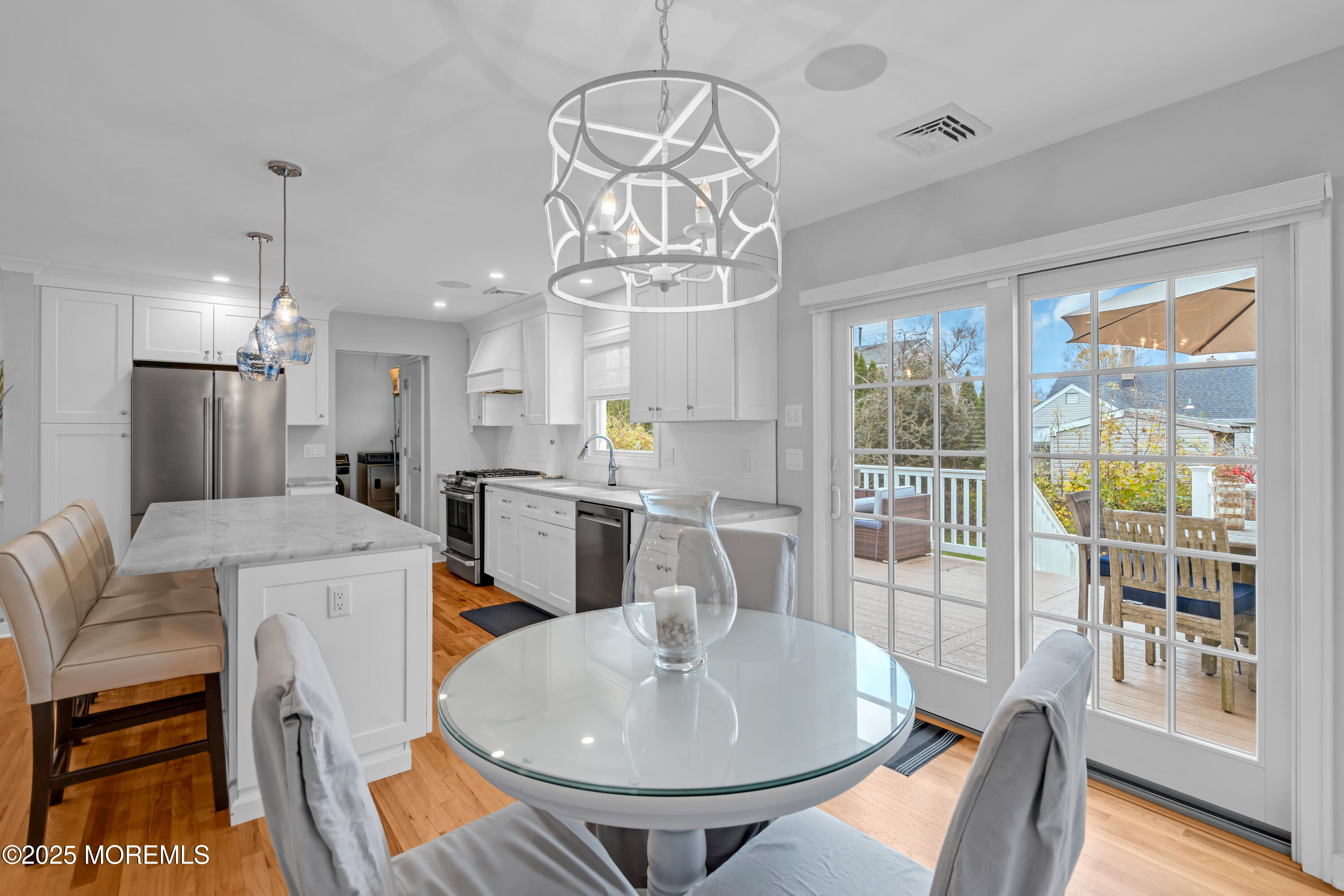 2419 Kipling Avenue Spring Lake Heights, NJ 07762 - Photo 12 of 37 a dining room with furniture a chandelier and wooden floor