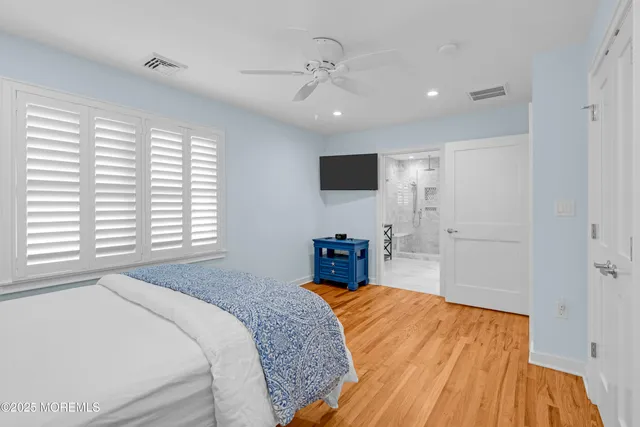 a bedroom with a bed and a flat tv screen