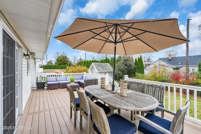 a view of balcony with furniture and umbrella