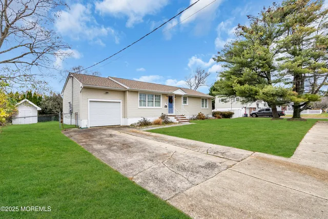 a front view of house with yard and green space