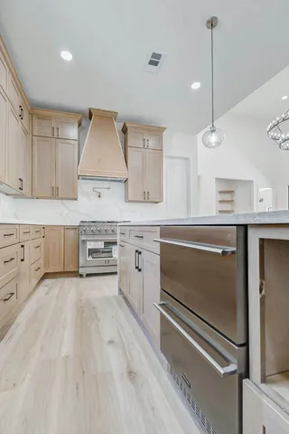 a kitchen with stainless steel appliances and white cabinets