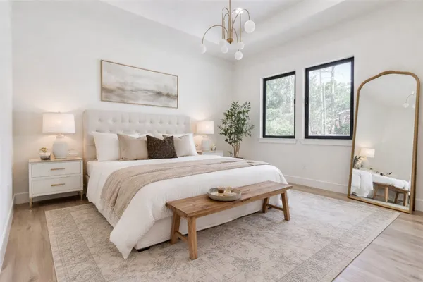 a view of a patio with couches plants and large tree