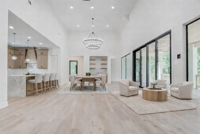 a kitchen with granite countertop white cabinets and wooden floor