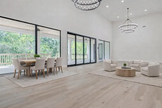a living room with furniture a window and a chandelier