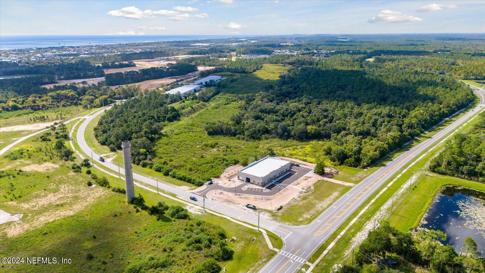6255 Colbert Lane Flagler Beach, FL 32136 - Photo 14 of 16 an aerial view of a house with a garden and lake view