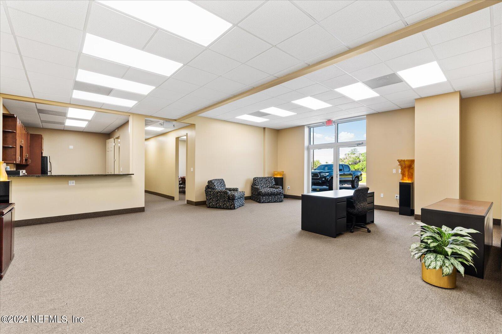 6255 Colbert Lane Flagler Beach, FL 32136 - Photo 8 of 16 a living room with furniture and a chandelier
