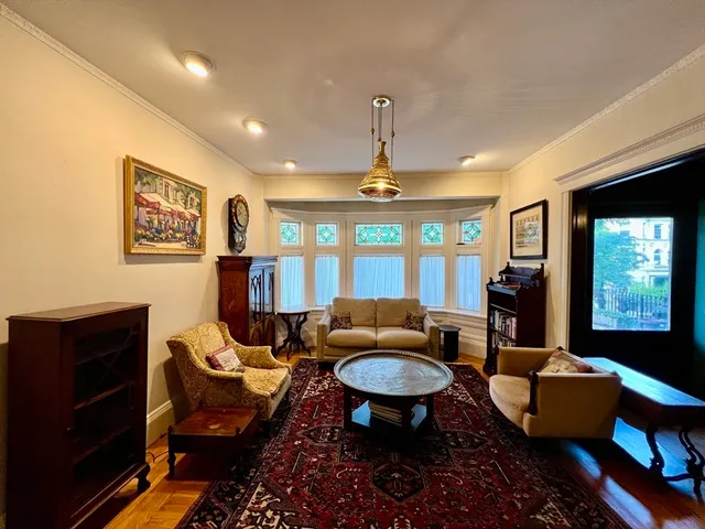 a living room with furniture a lamp and a window