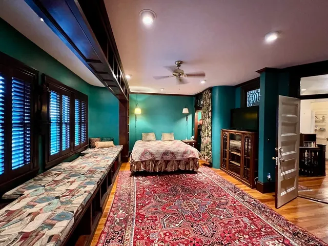 a bedroom with a bed dresser and flat screen tv