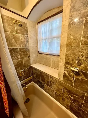 a bathroom with sink shower and a bathtub