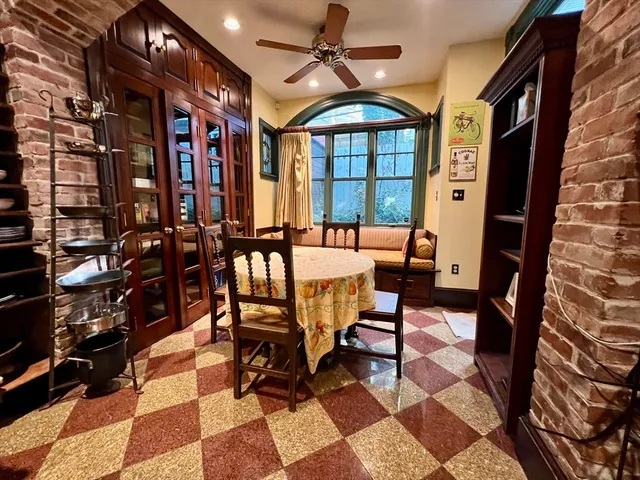 a dining room with furniture and a rug