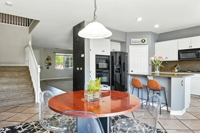 a kitchen with stainless steel appliances granite countertop a refrigerator and a stove top oven