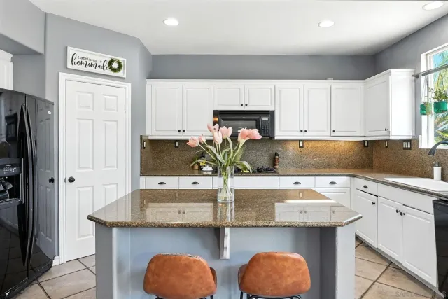 a living room with furniture a chandelier and a fireplace