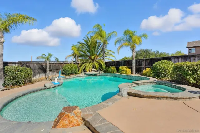 a view of a patio with table and chairs potted plants and palm tree