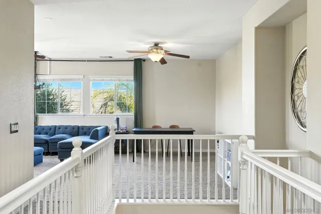 a spacious bedroom with a bed and a chandelier