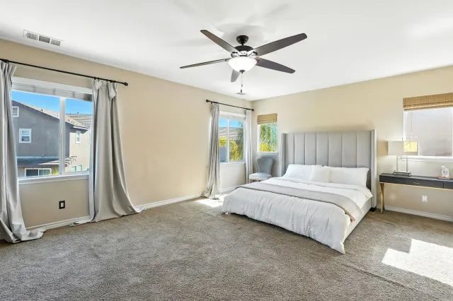 a bedroom with a large bed and a window