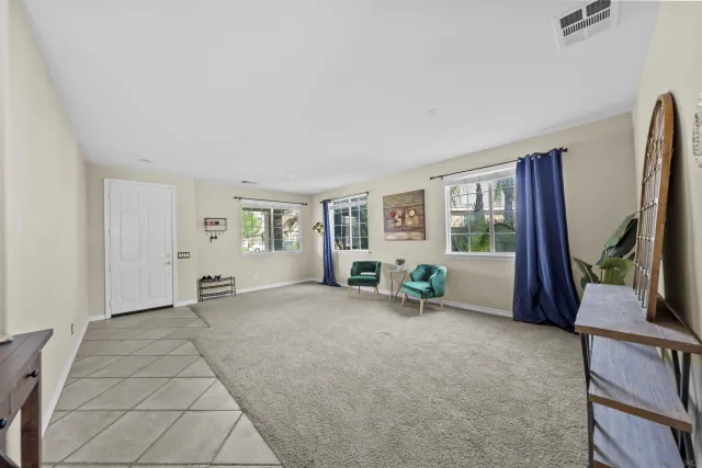 a kitchen with a table chairs and white cabinets