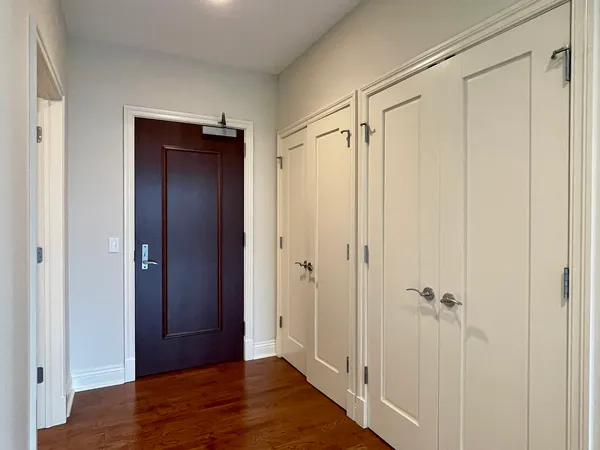 a view of a hallway with wooden floor