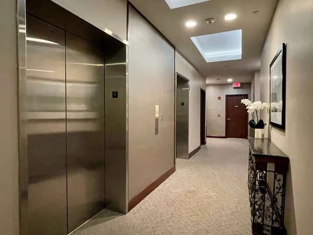 a view of hallway with walk in closet and bathroom